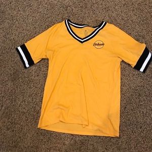 yellow, black, and white varsity shirt